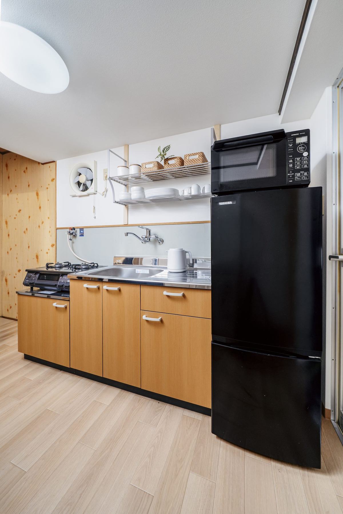 The kitchen, with a gas hob, sink, fridge and microwave